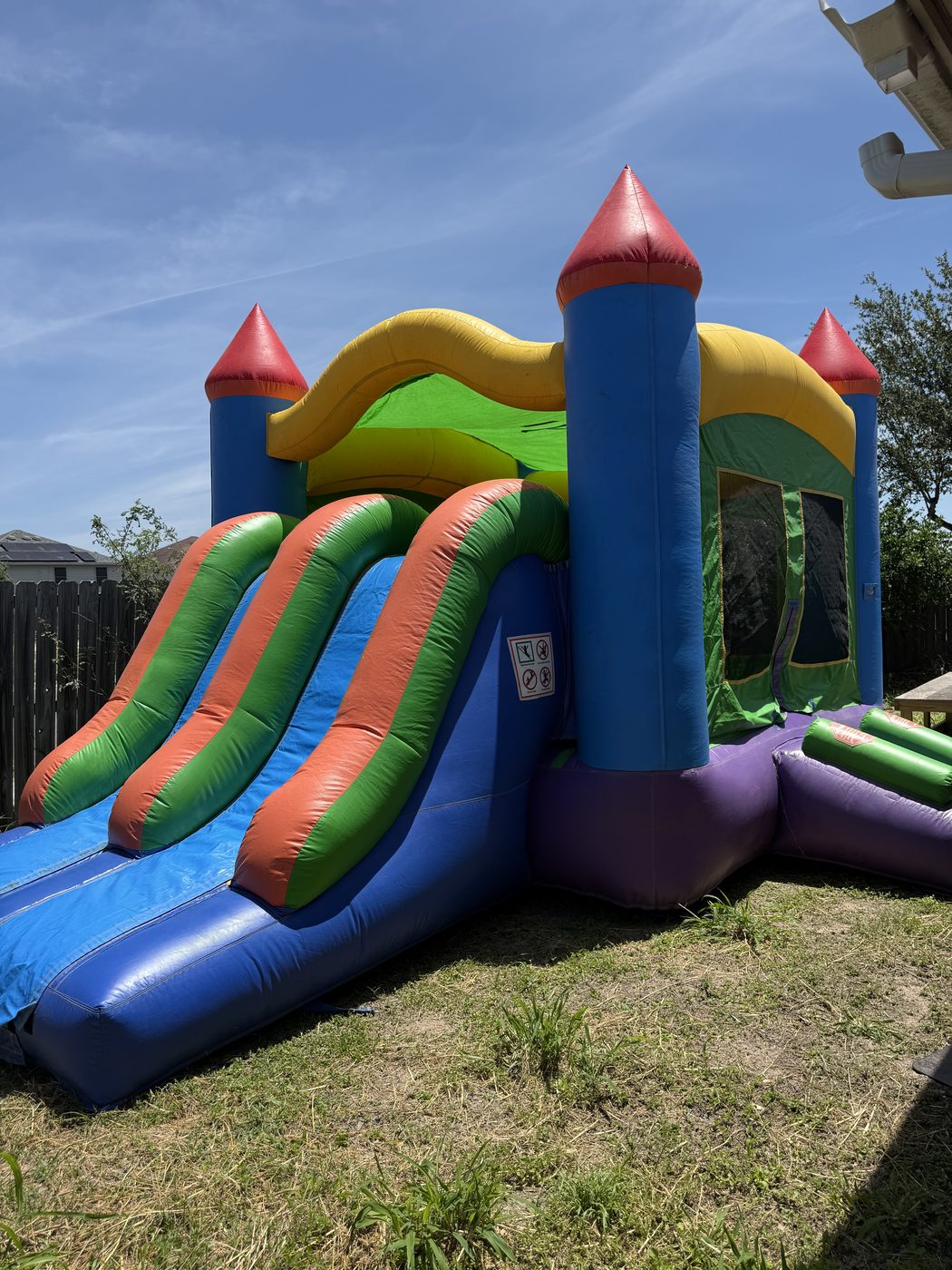 Grenitas — rainbow castle bouncer with single slide